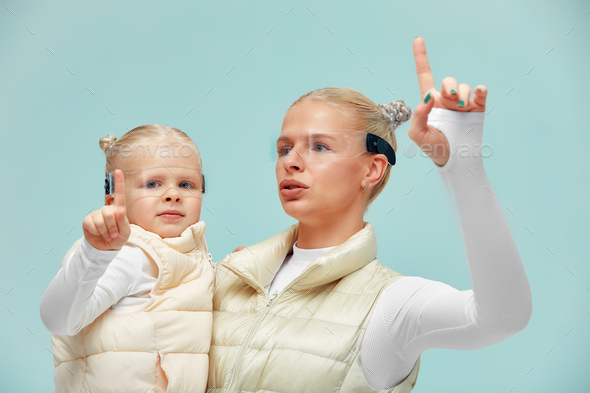 young woman with little girl wearing head mount display and futuristic GUI, smart glasses, graphical