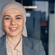 Smiling muslim businesswoman in hijab waving hi during work in modern office - PhotoDune Item for Sale