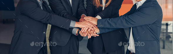 Happy group of multi ethnic coworkers stacked hands together as concept of corporate unity - Stock Photo - Images