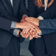 Happy group of multi ethnic coworkers stacked hands together as concept of corporate unity - PhotoDune Item for Sale