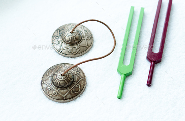 Two tibetan bells and tuning forks at white background - Stock Photo - Images