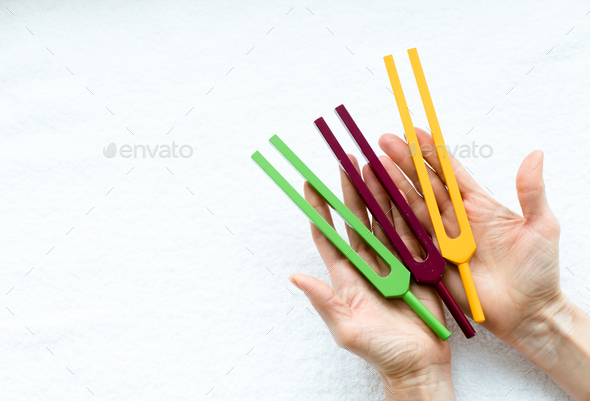 tuning forks in hands of woman - Stock Photo - Images