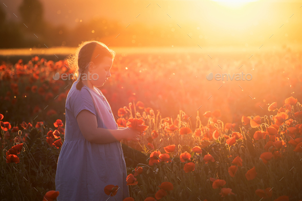 Child girl in a field of red poppies enjoys nature. Stock Photo by ...