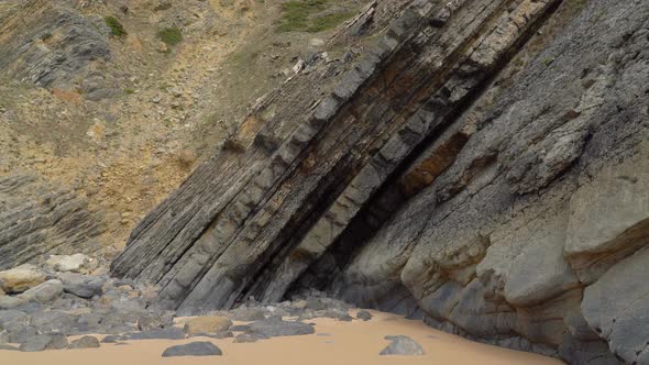 Tectonic Volcaninc Plates in the Beach of Gruta da Adraga in Portugal alt