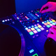Hands of a DJ creating and regulating music on dj console mixer at club concert - PhotoDune Item for Sale
