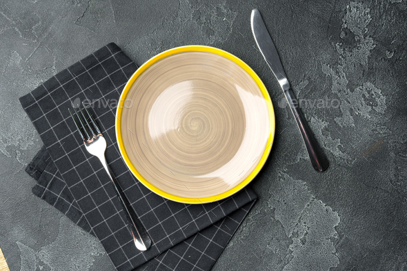 Top view of ceramic plate with table napkin on gray background - Stock Photo - Images