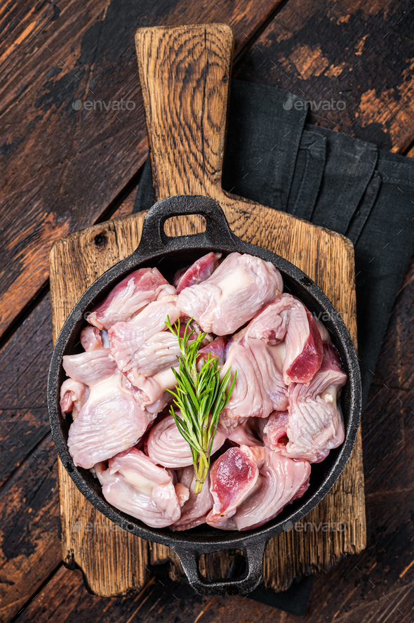 Raw chicken giblets gizzards, stomachs in a skillet ready for cooking