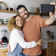 Couple taking a selfie standing in kitchen. - PhotoDune Item for Sale