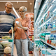 Happy senior woman and her husband buying groceries in the supermarket. - PhotoDune Item for Sale