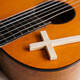Acoustic guitar with wooden cross on the table close up. Christian music. - PhotoDune Item for Sale