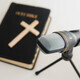 Bible book with microphone on table. Christian radio broadcast. Man records a online podcast. - PhotoDune Item for Sale