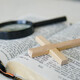 Open Holy Bible with a cross and magnifying glass. The concept of Bible learning. - PhotoDune Item for Sale
