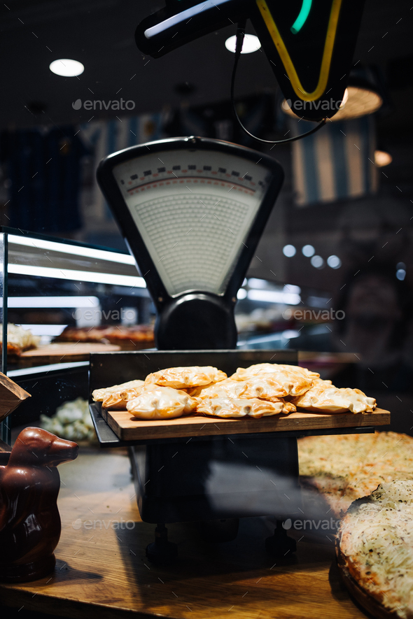 Vintage table with vintage scales. Cafe display case with baked goods
