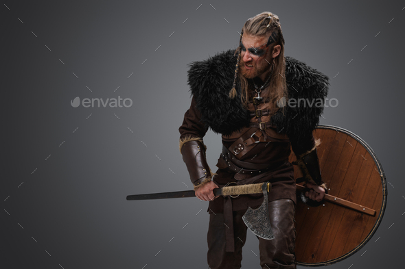 Furious viking from past holding shield and hatchet Stock Photo by fxquadro