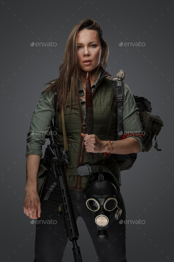 Bandit woman with bloody knife in post apocalyptic setting Stock Photo