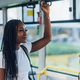 African american woman riding in a bus and holding a bar - PhotoDune Item for Sale