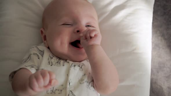 Baby Lies on Her Back and Smiles