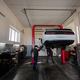 Two mechanic in service repair station working with muscle car in lift. - PhotoDune Item for Sale