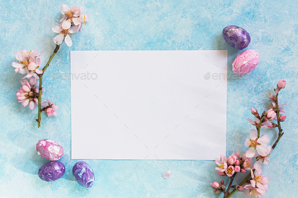 Happy Easter. Easter composition of colored eggs and almond flowers on a blue background. - Stock Photo - Images