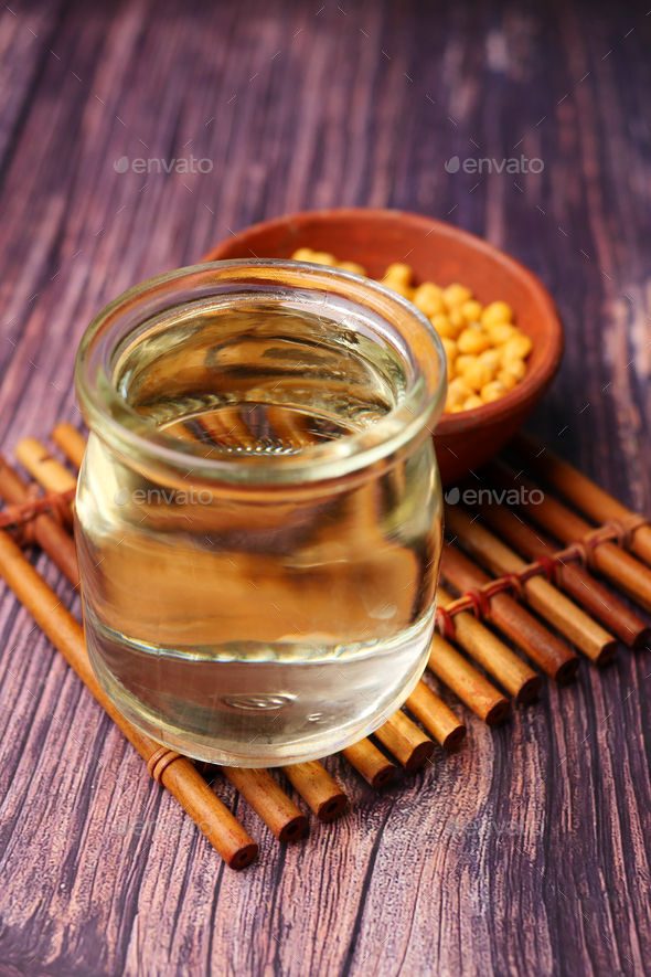 close up of Raw soy bean seed oil in a container  - Stock Photo - Images