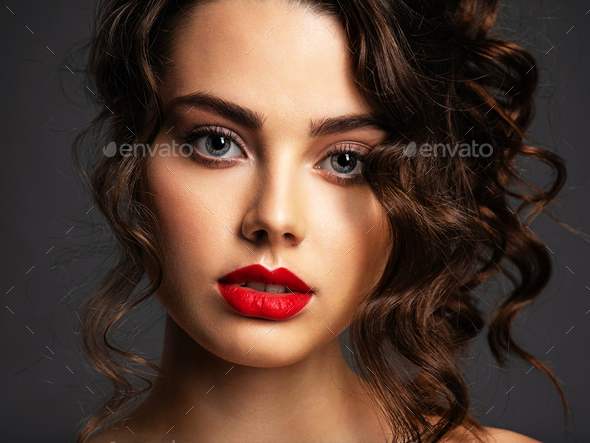 Face of a beautiful woman with a smoky eye makeup and red lipstick - Stock Photo - Images