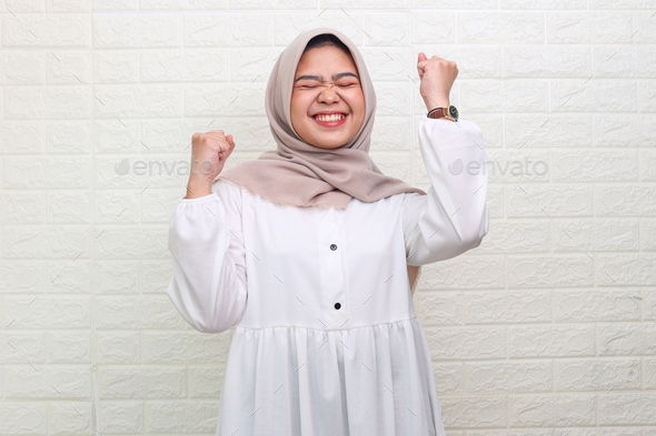 Attractive muslim teenager feeling so excited - Stock Photo - Images