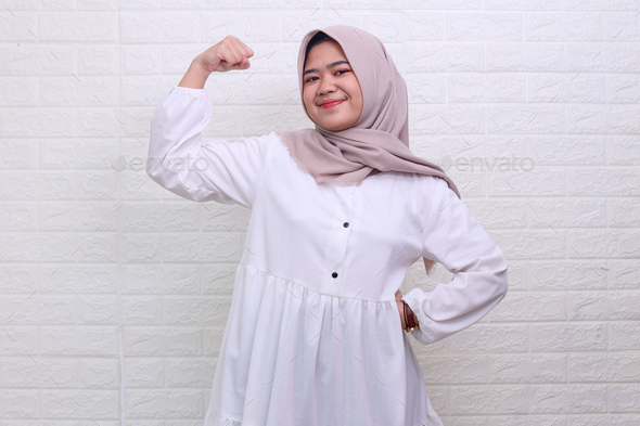 Young muslim woman gesturing strong hand facing ramadan fasting - Stock Photo - Images