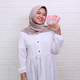 Muslim woman smiling while holds some money - PhotoDune Item for Sale