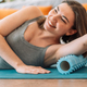 Lady kneading her triceps with foam roller - PhotoDune Item for Sale
