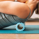 Lady kneading her back with foam roller - PhotoDune Item for Sale