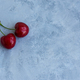 Two cherries on a gray background. - PhotoDune Item for Sale