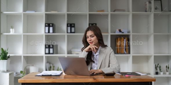 Portrait asian woman working with laptop in her office. business financial concept. - Stock Photo - Images