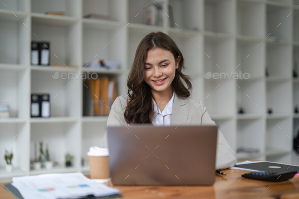 Portrait asian woman working with laptop in her office. business financial concept. - Stock Photo - Images