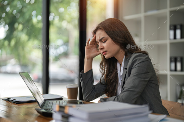 Migraine, stress and business woman in the office with a laptop working on a project with a - Stock Photo - Images