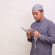 Asian Muslim man read or recite the Quran while holding prayer beads  - PhotoDune Item for Sale