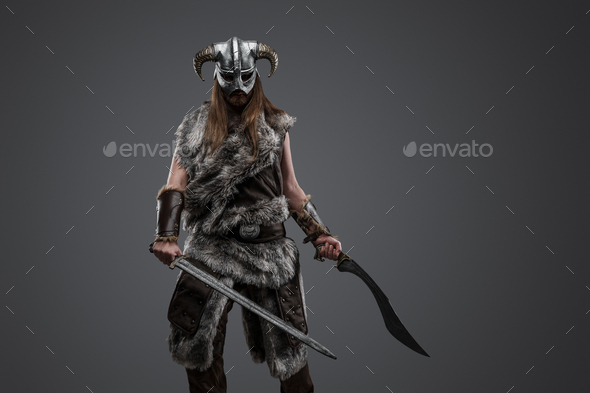 Viking from past with fur and paired swords - Stock Photo - Images