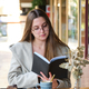 Young woman reading a book in a coffee shop. - PhotoDune Item for Sale