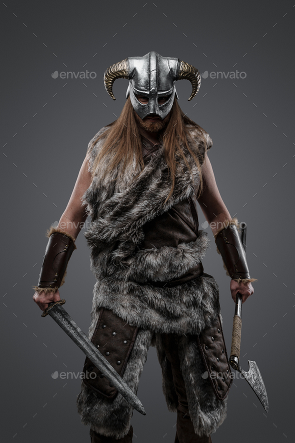 Long haired viking from past with sword and axe - Stock Photo - Images