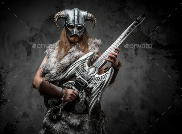Ancient viking rocker with guitar against dark background - Stock Photo - Images