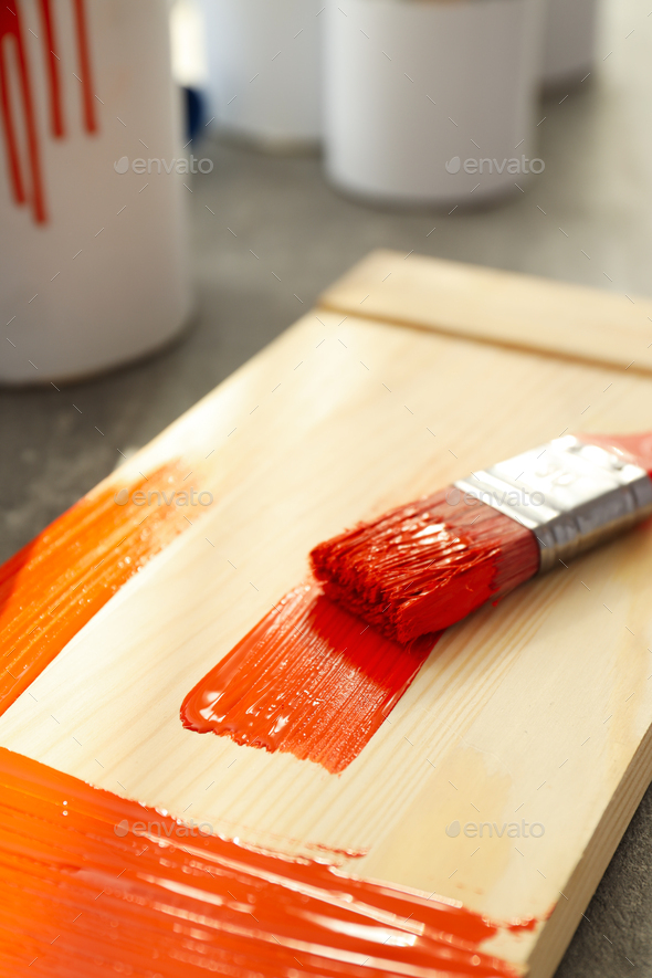 Board with brush with paint, close up - Stock Photo - Images
