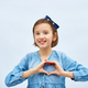 Smiling little girl make heart sign with hands - PhotoDune Item for Sale