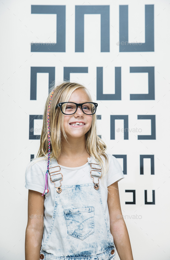 concept vision testing. child girl with eyeglasses - Stock Photo - Images
