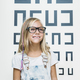 concept vision testing. child girl with eyeglasses - PhotoDune Item for Sale