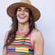Smiling woman in hat and colorful t-shirt. - PhotoDune Item for Sale
