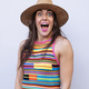 Surprised woman in hat and colorful t-shirt. - PhotoDune Item for Sale