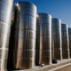 Steel modern cisterns for wine production on plant territory. Large tanks - PhotoDune Item for Sale