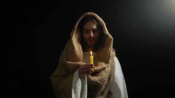 Male Alike Jesus Blowing on Candle After Gospel, Praying God, Spirituality alt