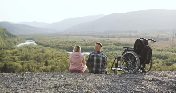 Family Leisure Concept Where Young Happy Loving Couple Where One of Them Is Invalid Sitting on the alt