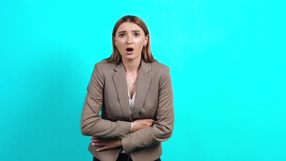 Young Woman in Business Style Jacket, Grimacing and Twitching in Pain, Stomach Pain, Indigestion alt