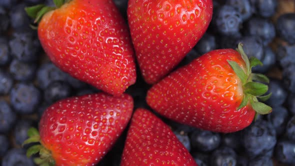 Close Up Of Strawberries Forming A Circle Laying On Top Of Blueberries Spinning 04